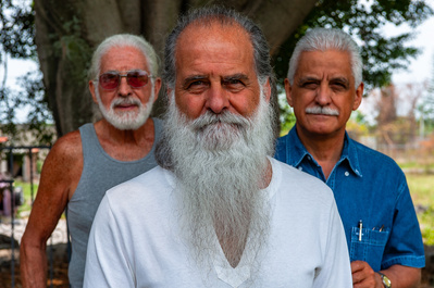 Close up of three Hispanic brothers in central Mexico enjoying their decades long friendship