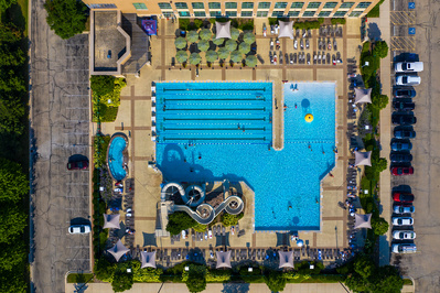 Bird eye's view of the outdoor pool and slide of a fitness club