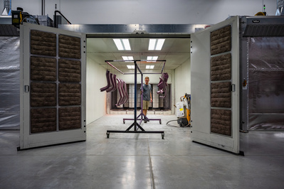 Custom automotive parts being unloaded from a paint room