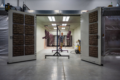 Custom automotive parts being unloaded from a paint room