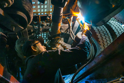 Truck and trailer welding job performed underneath the vehicle