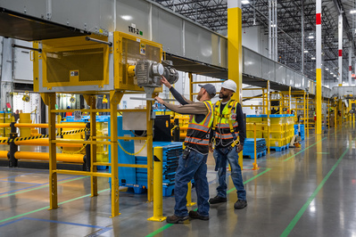Product photography services showing two service technicians inspecting equipment at a large distribution facility