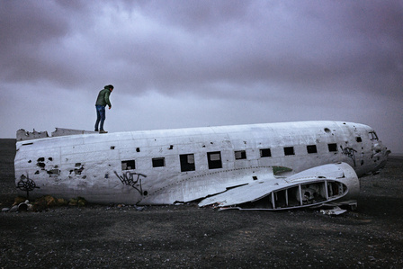 A man investigates the Sólheimasandur plane crash site along the 
