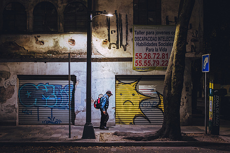 A pedestrian saunters through the La Condesa neighborhood of Mexico City, Mexico. 