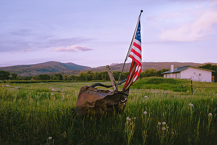 A tattered flag and old car door near Driggs, Idaho, USA.