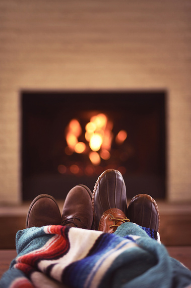 Romance book cover image, boots by the fireplace, cozy couple