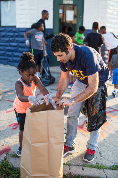 Nate, a candidate for Maryland State Delegate cleaning up in a neighborhood in Baltimore City Maryland during a campaign photo shoot.