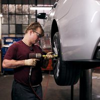 Portrait of employee working on a vehicle.