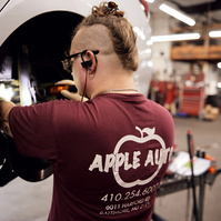 Portrait of employee working on vehicle.