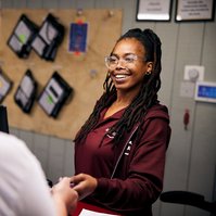 Portrait of employee working with business customer.