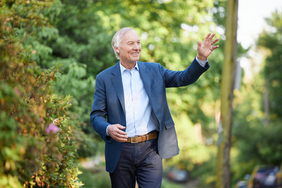 Candidate for governor waving to crowd at a political event.