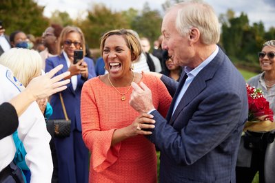 Maryland politicians Peter Franchot and Monique Anderson Walker laughing at campaign event together.