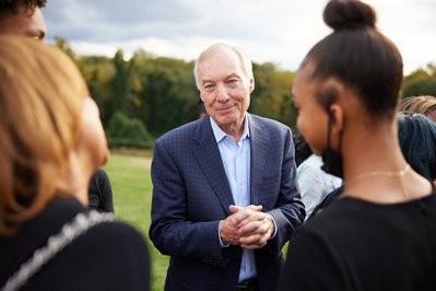 Candidate for governor engaging with the crowd at a political event.
