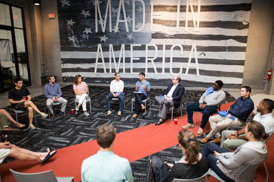 Maryland State Delegate candidate leading a conversation during a political event in Baltimore City Maryland.
