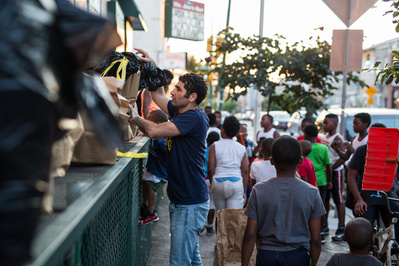 Nate, candidate for Maryland State Delegate cleaning up in a neighborhood in Baltimore City Maryland during a campaign photo shoot.