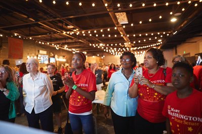 Photograph of State Senator Mary Washington celebrating with crowd at political campaign event.