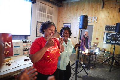 State Senator Mary Washington celebrating with supporter at campaign event.