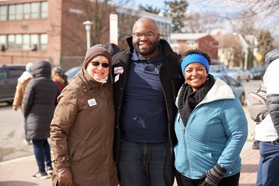 State Senator Mary Washington posing with politicians at campaign event.