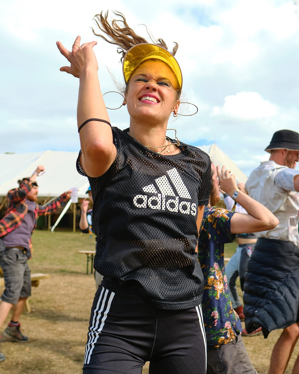 a stylish woman raver dancing in Adidas clothing. El Dorado music festival.