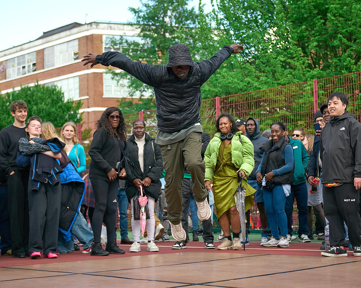 A Bboy flying in a stance at Breakin Convention Park Jam 2025
