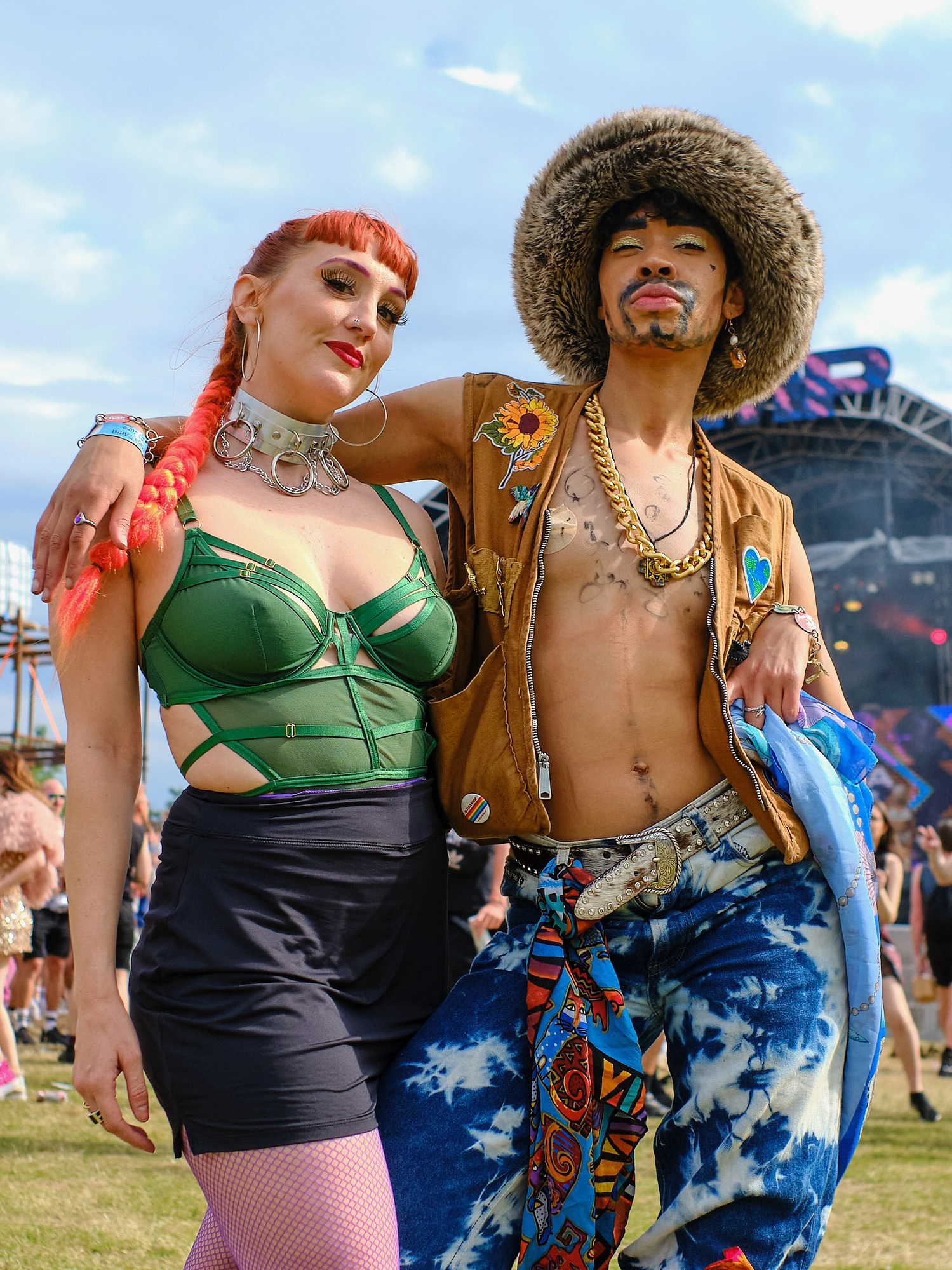 stylish LGBTQ+ couple pose for a street portrait in front of the stage