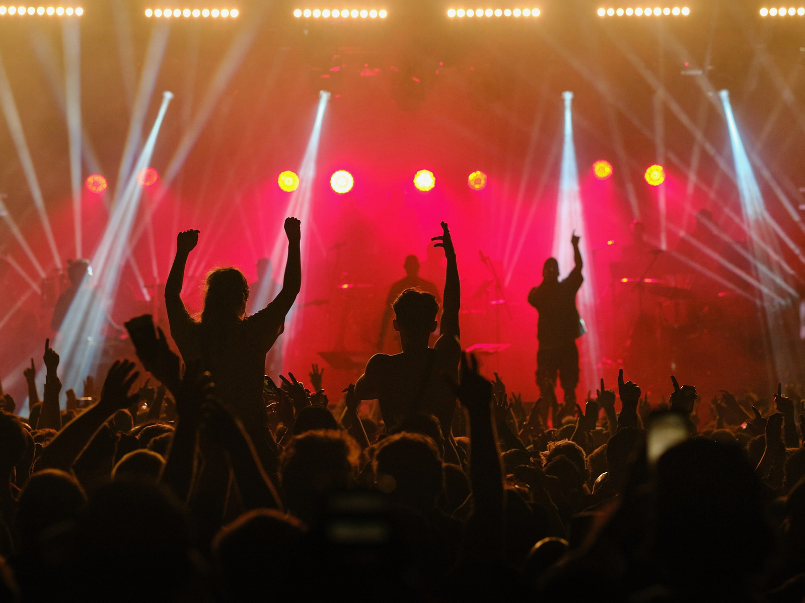 The crowd dance and rave with their hands in the air to drum and bass music at project 6 festival