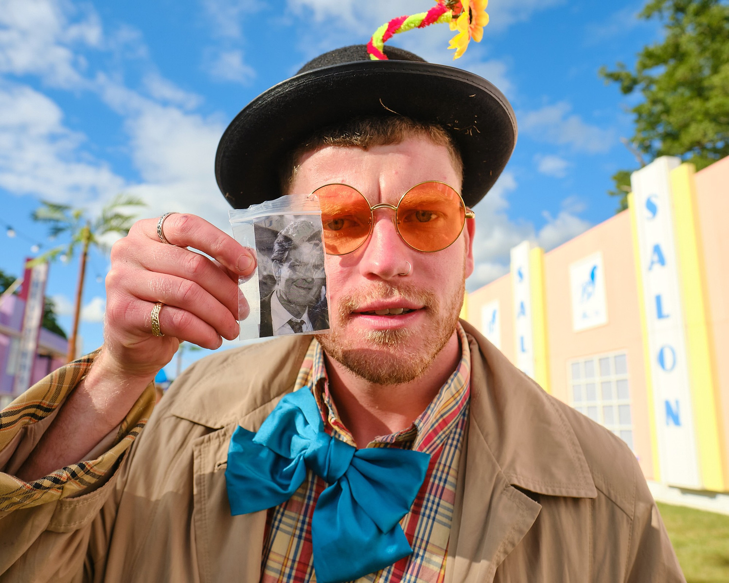 a man in costume holds up a bag of charlie