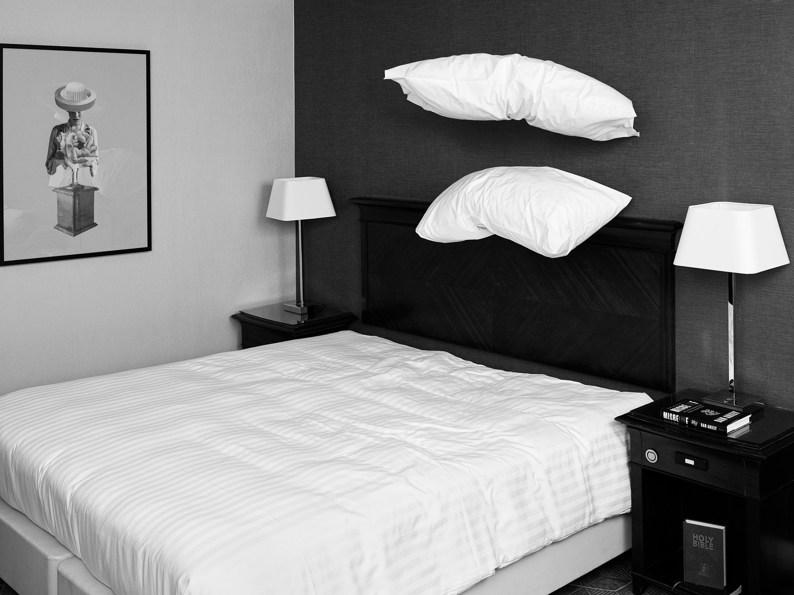 Black and white image of hotel room with two white pillows floating above neatly made bed.
"Dreams Unbound" - The surreal intersection of rest and restlessness in temporary dwellings. Camera Hasselblad Flexbody 50 CFV ii