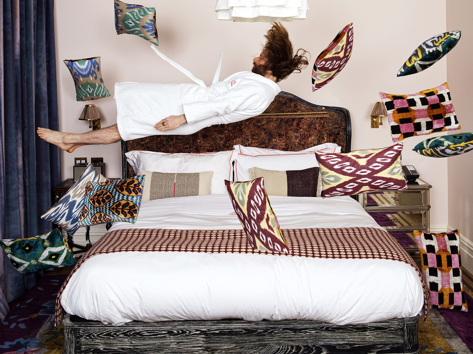 Man in white robe leaping on luxury hotel bed surrounded by flying pillows
"Unleashed Whimsy" - Experimental Hospitality Photography Capturing Joyful MomentsCamera Hasselblad Flexbody 50 CFV ii