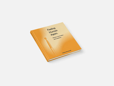 A small orange book with the title "Feeling Human Again."