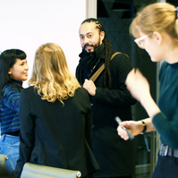 A group of people greeting and introducing themselves to each other. 