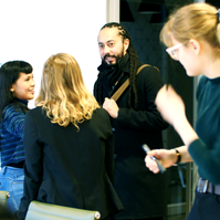 A group of people greeting and introducing themselves to each other. 
