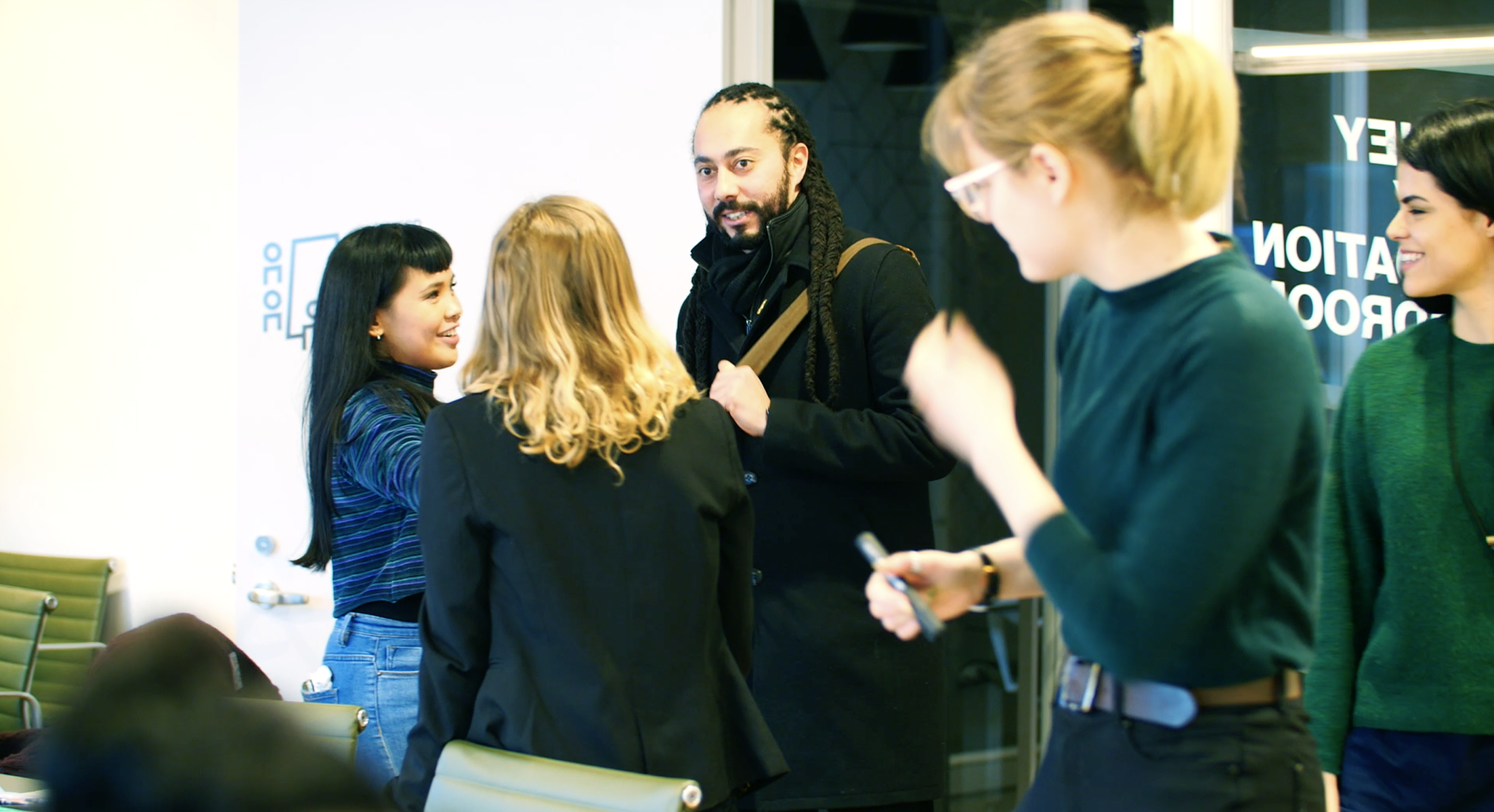 A group of people greeting and introducing themselves to each other. 