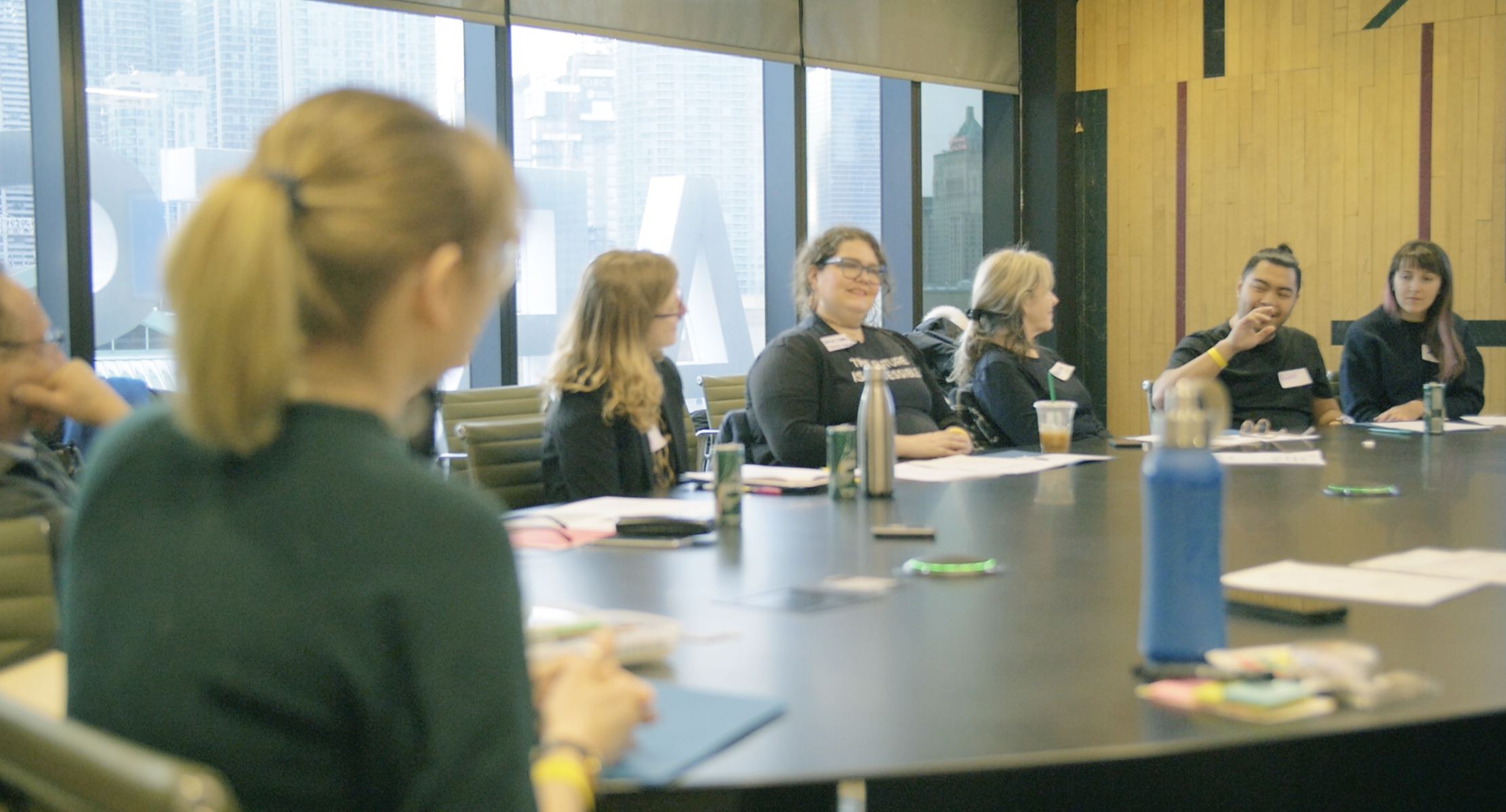 A group of people sitting a round table.
