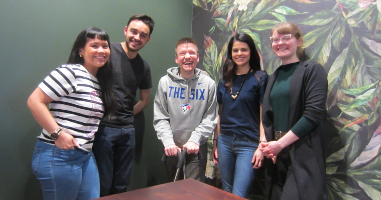 Five people smiling together.