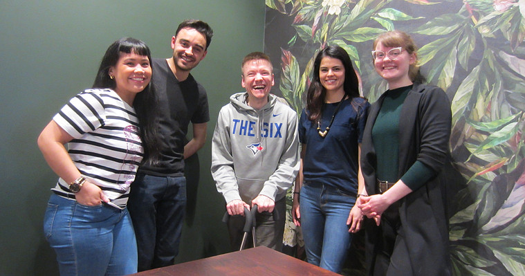 Five people smiling together.