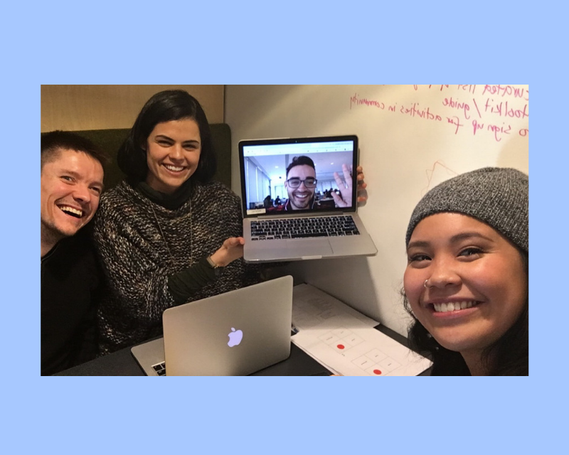 People smiling with their laptops and one person holding a laptop with person a virtual call.