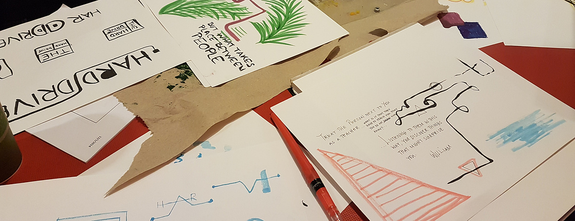 Sheets of paper with different illustrations of 'The Hard Drive' and quotes.