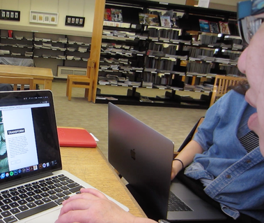 A person navigating a website on a laptop.