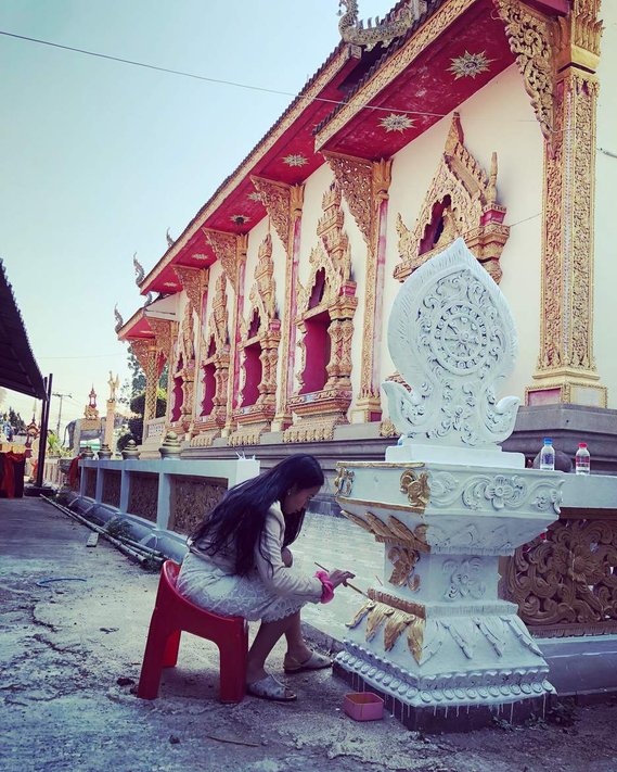 Helping monks paint a local temple in  Chiang Rai, Thailand 
