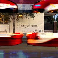 Text that reads "I love you, still." sprayed on an off white brick wall. A composite of the streetcar passing by overlays the image surrounding the text. By Leilah Dhoré in Toronto, Ontario