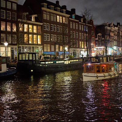 boats in canal at night Amsterdam