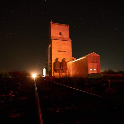 Night train coming up to Dufresne grain elevator in Manitoba Canada.