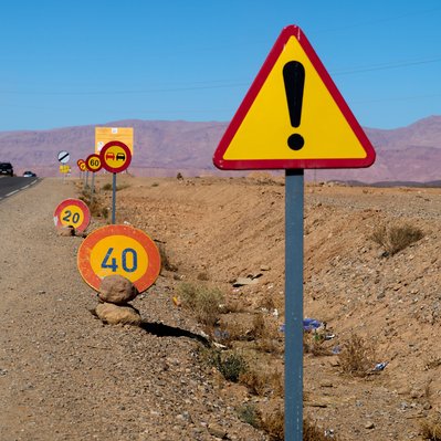 A photo of many confusing highway signs in a row in Morocco