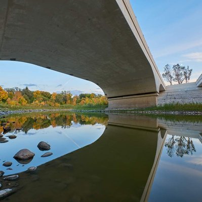 Winnipeg bridge with fall colours from the trees along the banks of the La Salle River.
