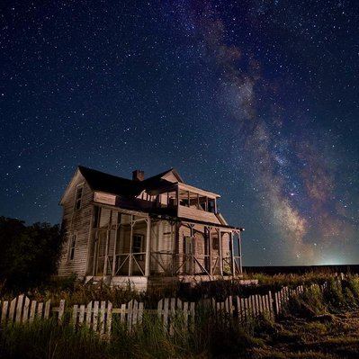 Milky Way over abandoned homestead located in prairie region of Manitoba. 