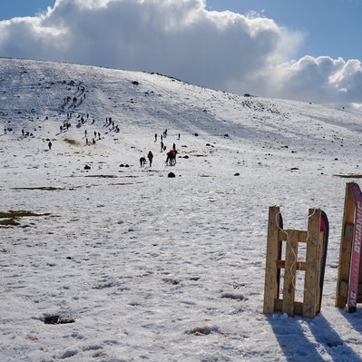 Moroccan landscape photograph featuring skiing and sledding in the Atlas Mountains.