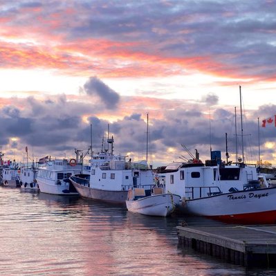 Pink sunrise over fishing vessels in Gimli harbour, Manitoba.