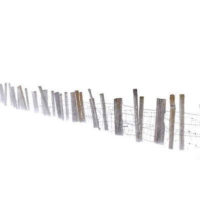 A set of old fence posts lost in a prairie blizzard in Manitoba Canada