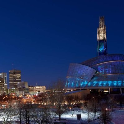 The Winnipeg Human Rights Museum with a northern lights glowing interior. Located in Winnipeg Manitoba.